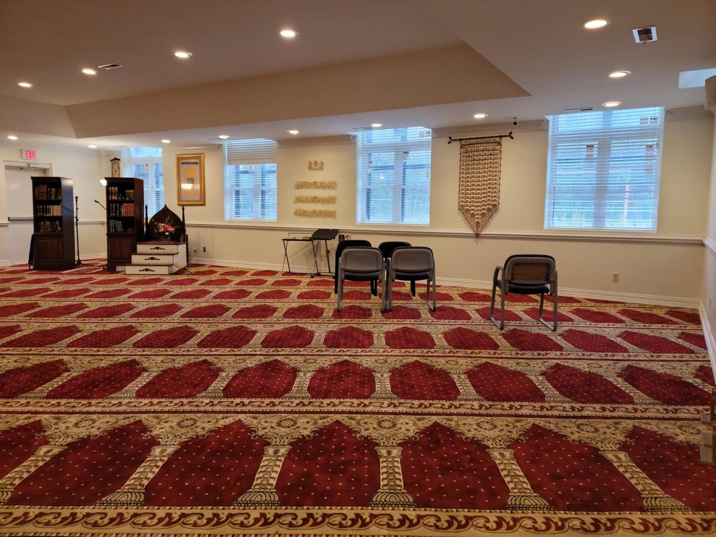 The prayer hall, with its red and gold carpet and the minbar at the front